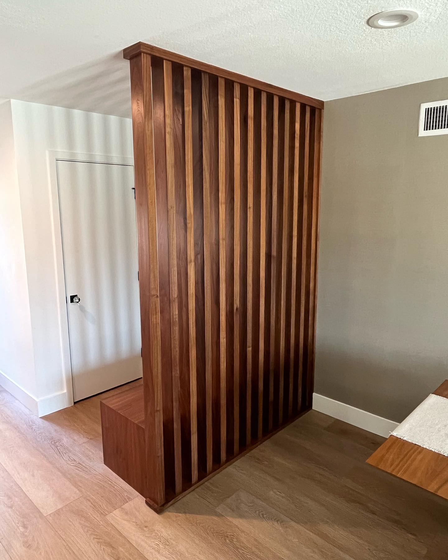 Featured image for “Custom partition with mudroom style seat and storage. The vertical posts are 2”x4” solid walnut milled from 10/4 slabs.”